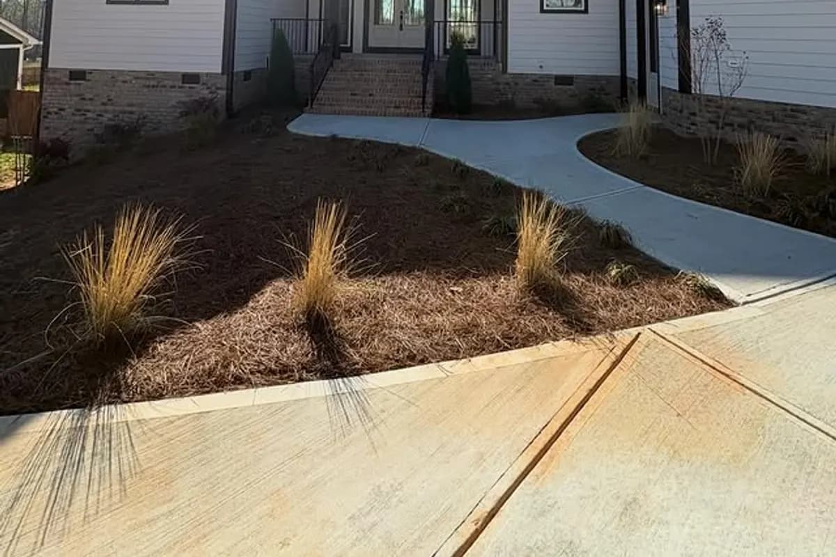 Ratcliff Properties custom home exterior with landscape beds and walkway near Harrisburg NC