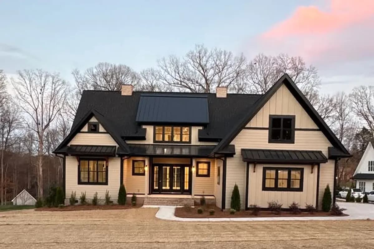Ratcliff Properties custom home exterior with evening lighting and curb appeal